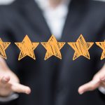 image of woman holding five stars review